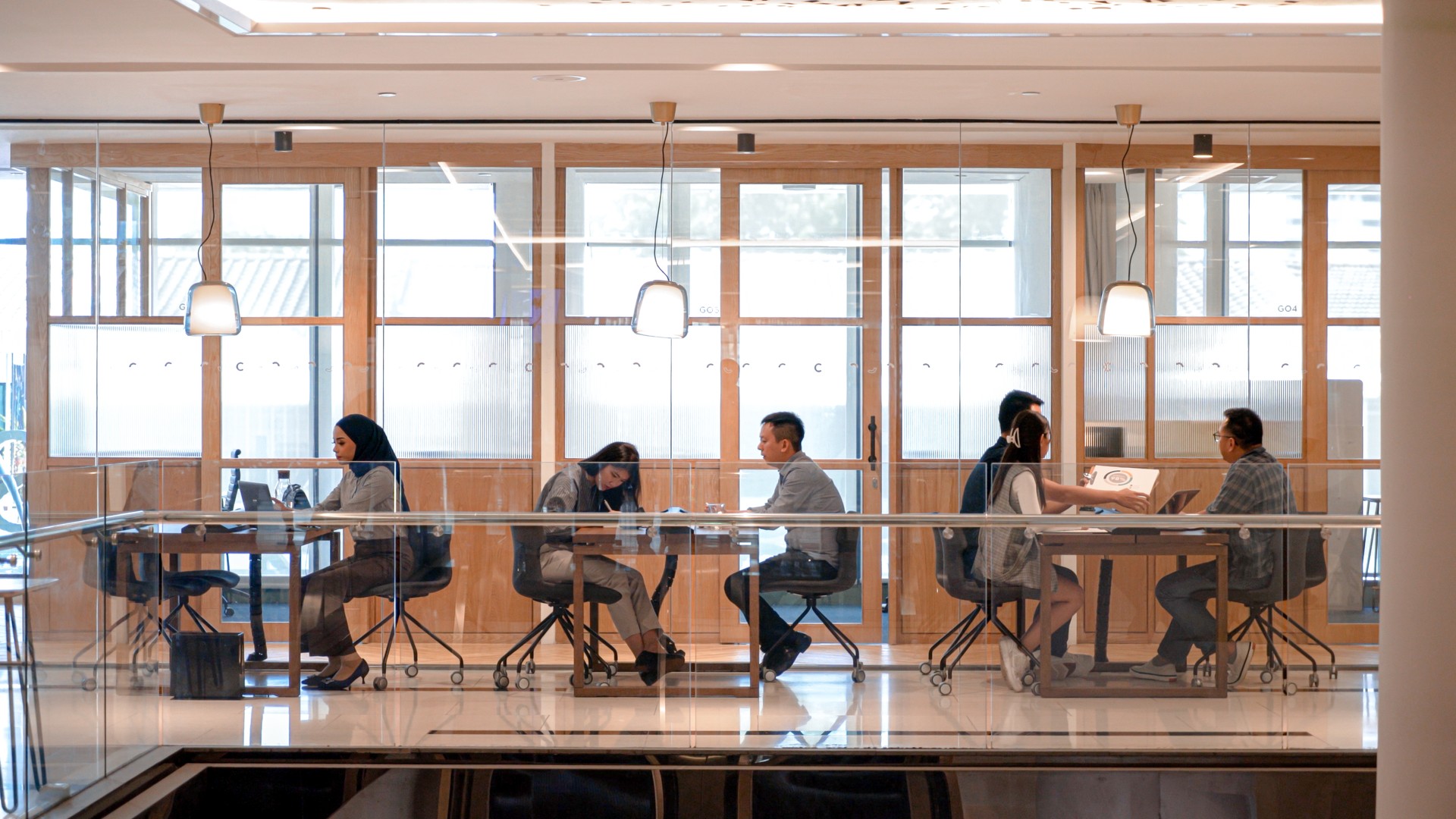 Busy Asians working in an open co-working space